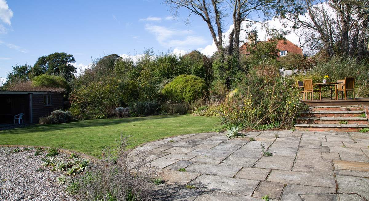 The patio with steps leading up to the decking where you can sit by the pond and admire the view.