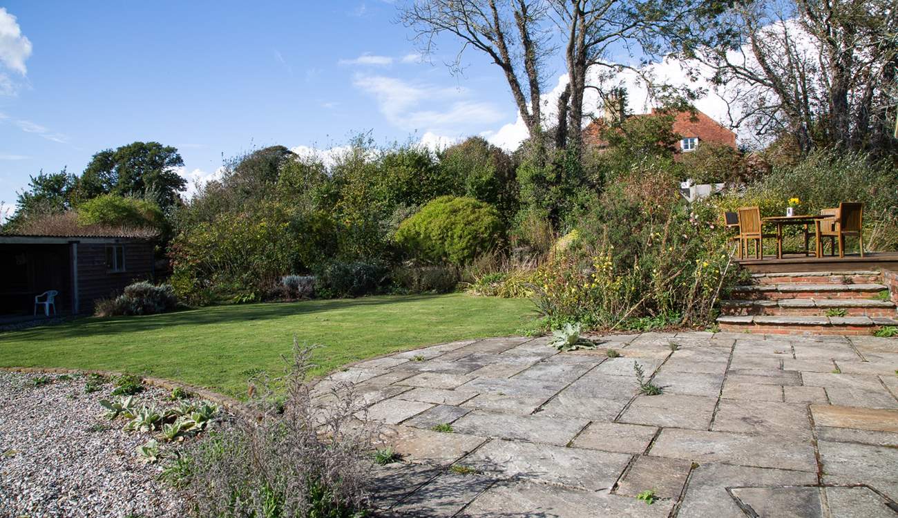 The patio with steps leading up to the decking where you can sit by the pond and admire the view.