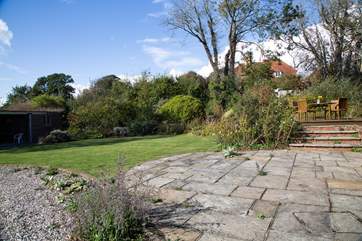 The patio with steps leading up to the decking where you can sit by the pond and admire the view.