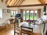 The spacious open plan living-room has exposed beams.