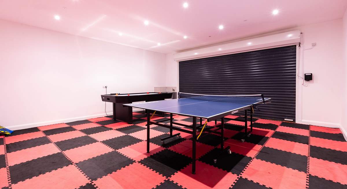 The garage is set up as a games-room offering table-tennis and table-football. 