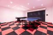 The garage is set up as a games-room offering table-tennis and table-football. 