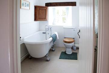 The main bathroom is upstairs and has the luxury of a roll-top bath.