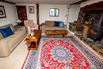 The sitting-room benefits from being a generous size with enough seating for all the family and everyone will enjoy the glow of the log-burner.