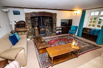 The sitting-room benefits from this wonderful wood-burner for those autumnal nights and not forgetting those wonderful views from the window seat.