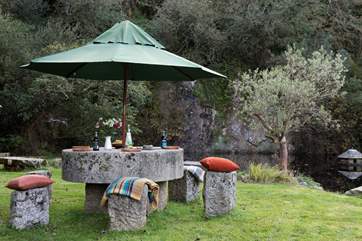 The outside dining table is cleverly made out of an old mill stone.