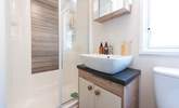 The separate shower room is complete with a shower, WC, wash basin, plus a heated towel rail.  - Thumbnail Image