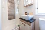 The separate shower room is complete with a shower, WC, wash basin, plus a heated towel rail. 