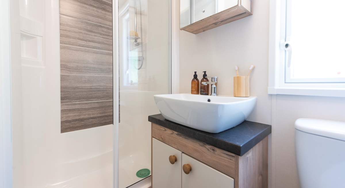 The separate shower room is complete with a shower, WC, wash basin, plus a heated towel rail. 