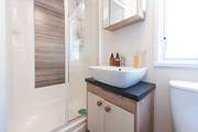 The separate shower room is complete with a shower, WC, wash basin, plus a heated towel rail.