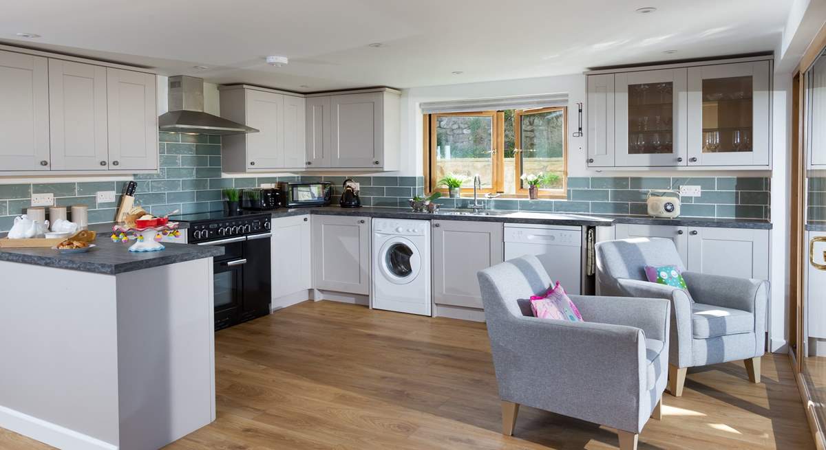 The well-equipped kitchen has two armchairs perfectly positioned so that you can sit and enjoy the view of the moorland. 