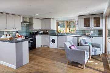 The well-equipped kitchen has two armchairs perfectly positioned so that you can sit and enjoy the view of the moorland.