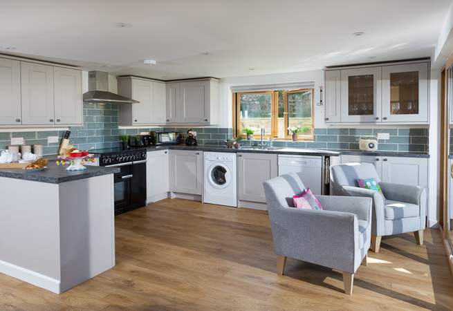 The well-equipped kitchen has two armchairs perfectly positioned so that you can sit and enjoy the view of the moorland. 