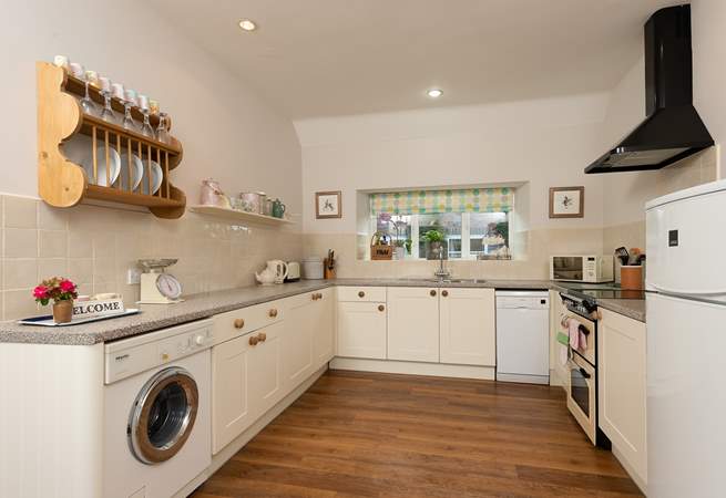 A lovely country-style kitchen is equipped to the highest standard.