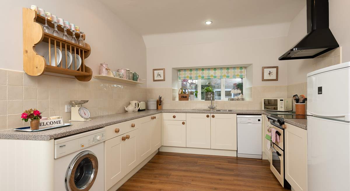 A lovely country-style kitchen is equipped to the highest standard.