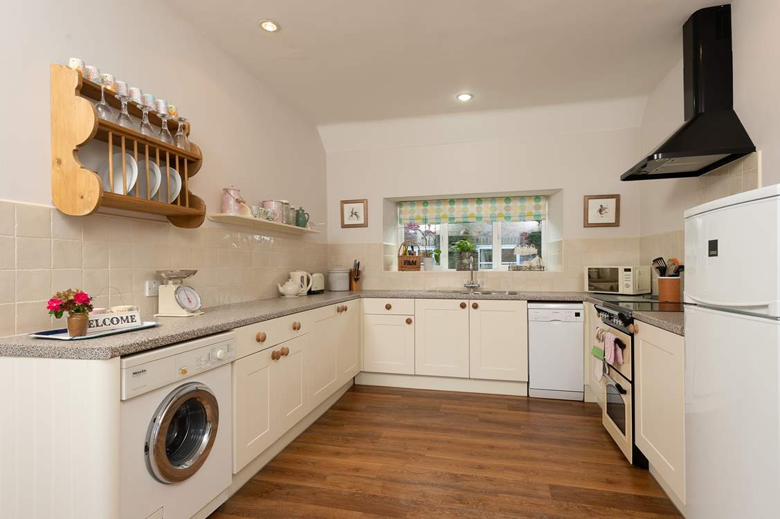 A lovely country-style kitchen is equipped to the highest standard.