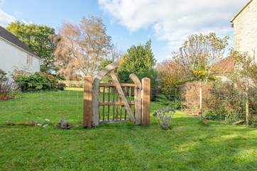 The other side of the beautiful gate is the owners' garden, with their house to the left.