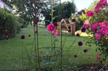 The beautiful garden is full of flowers and the lovely gate sections off your private area of lawn. The owners' house is on the left but you have lots of privacy.