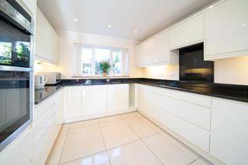 The sleek modern kitchen offers plenty of space to cook up a special family treat!