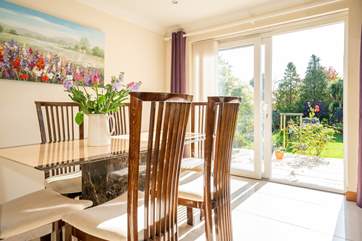 The sitting/dining-room leads out to the patio and garden area, ideal for the family to all spread out.