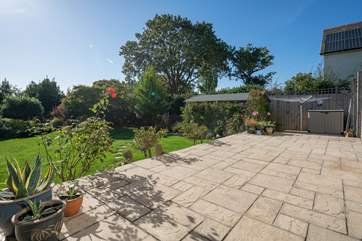 Admire the vast amount of plants and flowers surrounding the large garden and patio area.