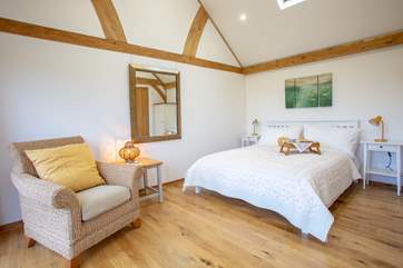 The beautifully furnished bedroom with king-size double bed and lovely linens.