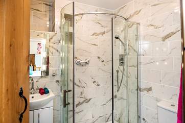 The stylish shower-room leads off from the bedroom-area.
