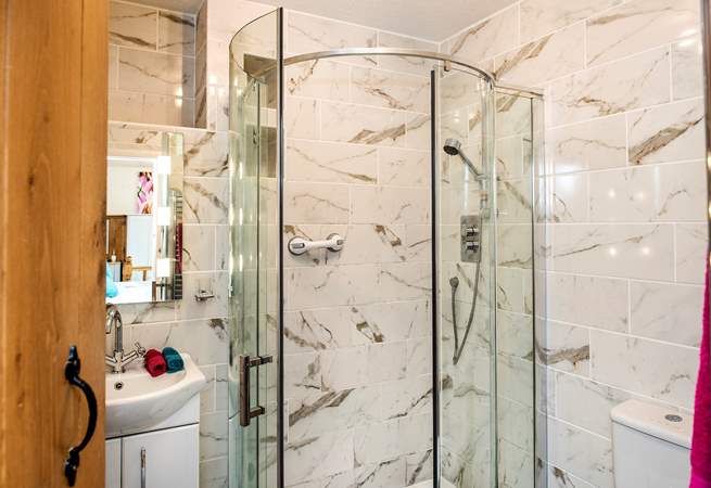 The stylish shower-room leads off from the bedroom-area.