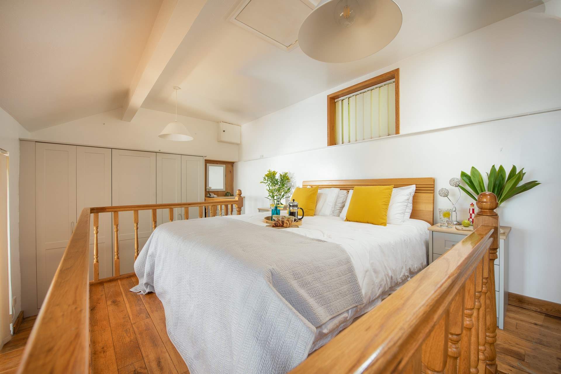 The bed is located on a mezzanine floor at the back of The Hideaway.