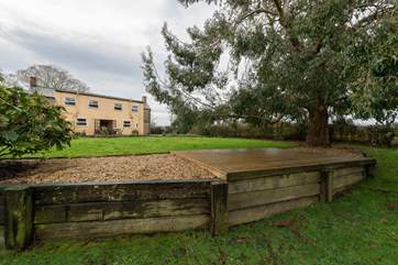 Outside, the garden is very large - children and dogs will love exploring! Please take care as there is a drop from this raised area.