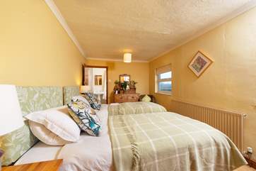 This pretty twin bedroom has two doors; one through to the shared en suite, and one out to the landing.