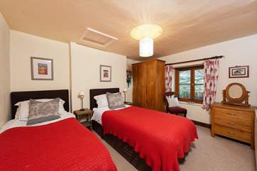 This pretty twin room has dual-aspect windows; both capturing the countryside views.
