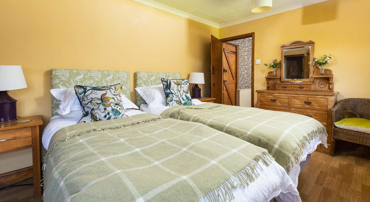 This pretty twin bedroom has two doors; one through to the shared en suite, and one out to the landing.