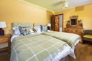 This pretty twin bedroom has two doors; one through to the shared en suite, and one out to the landing.