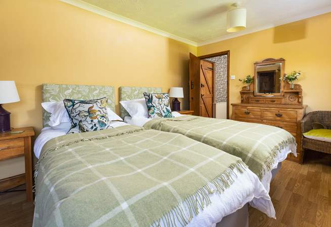 This pretty twin bedroom has two doors; one through to the shared en suite, and one out to the landing.