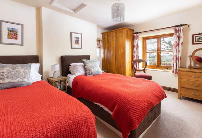 This pretty twin room has dual-aspect windows; both capturing the countryside views.