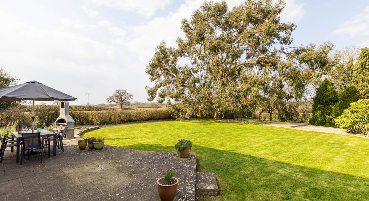 Outside, the garden is very large - children and dogs will love exploring! Please take care as there is a drop from this raised area.