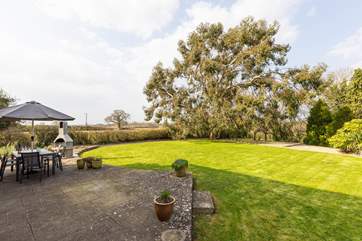 Outside, the garden is very large - children and dogs will love exploring! Please take care as there is a drop from this raised area.