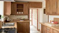 Entry into the kitchen via the handy boot-room off the parking area.