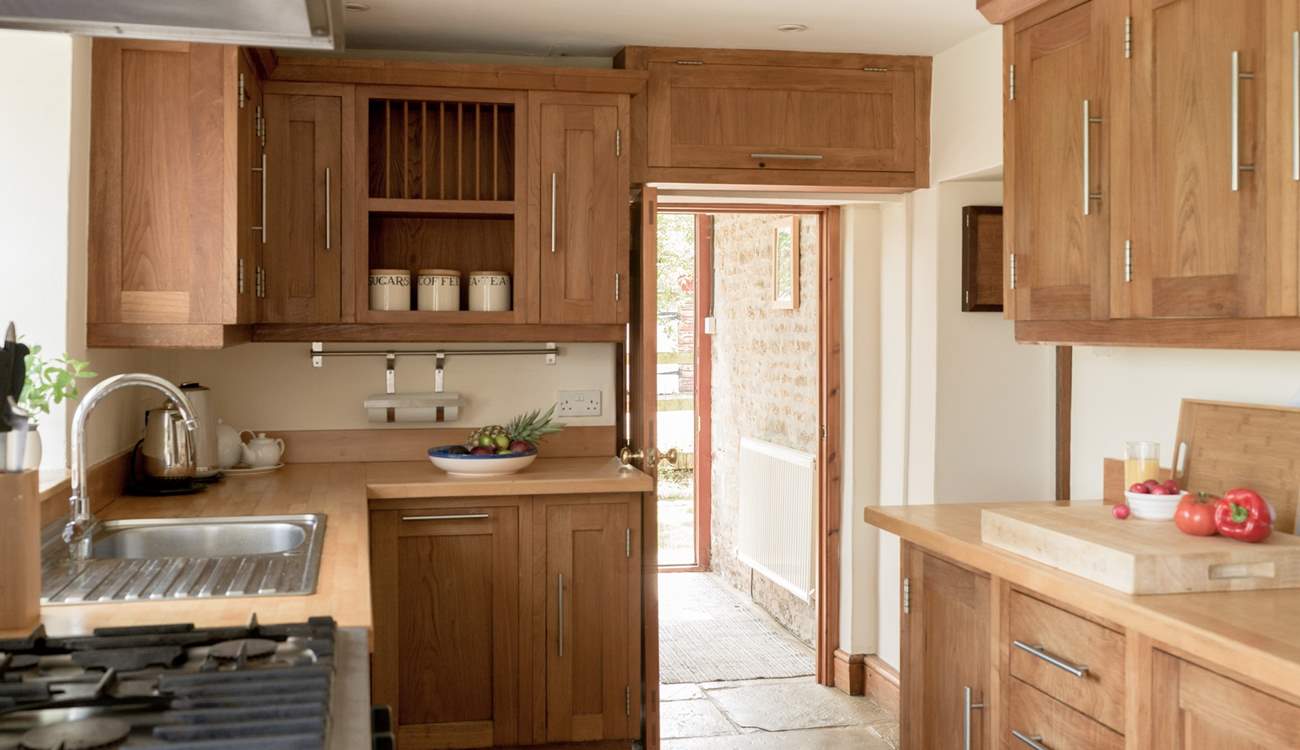 Entry into the kitchen via the handy boot-room off the parking area