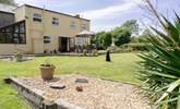 The cottage boasts a large private garden with spacious raised patio and plenty of outdoor seating - Thumbnail Image