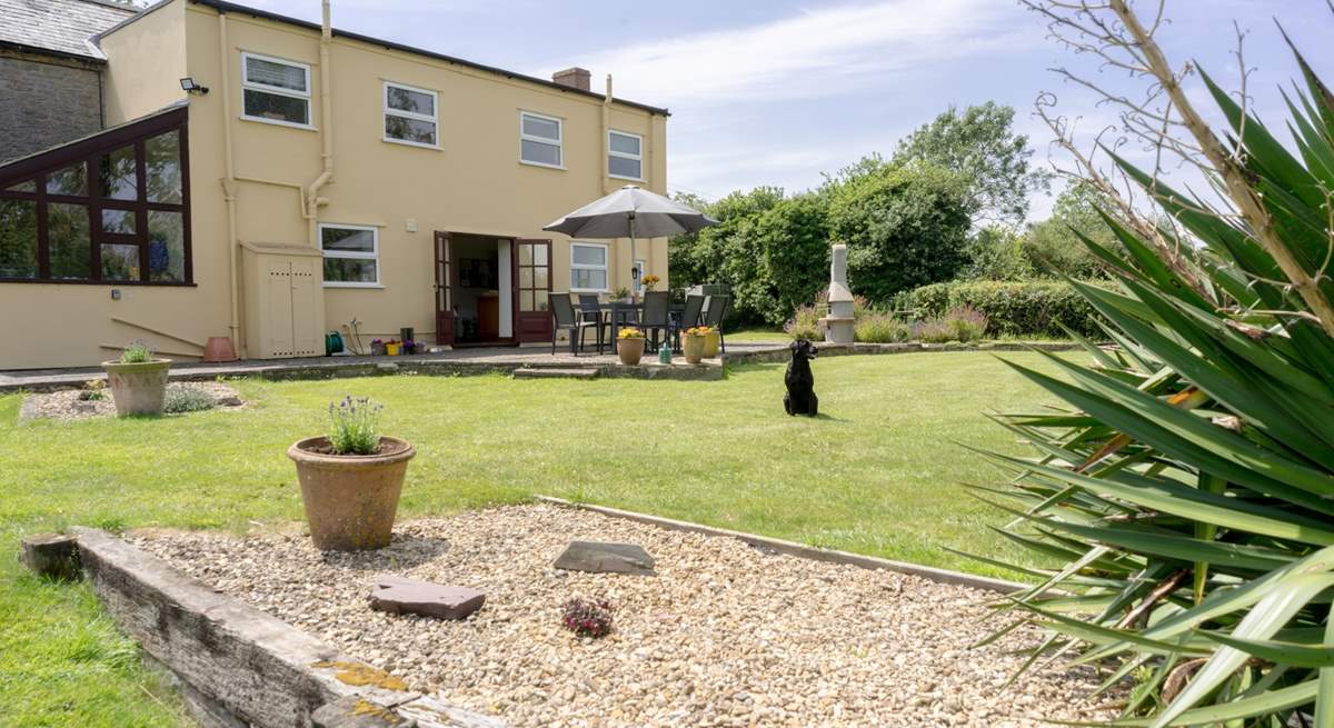 The cottage boasts a large private garden with spacious raised patio and plenty of outdoor seating