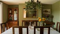 The striking formal dining-room seats eight and has a beautiful ornamental feature fireplace.