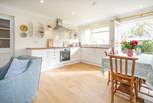 The light and airy open plan living-room with kitchen and dining areas.