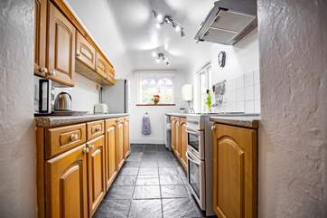 The kitchen floods with light and has wonderful views of the platform. At the end of the kitchen you will find a small utility area and the downstairs WC.