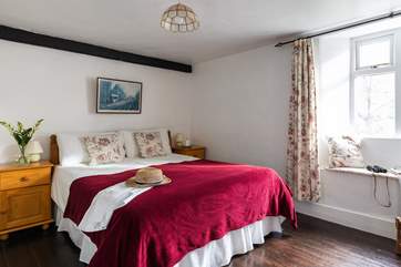 The main bedroom is a comfortable size overlooking the platform at the back of the house.