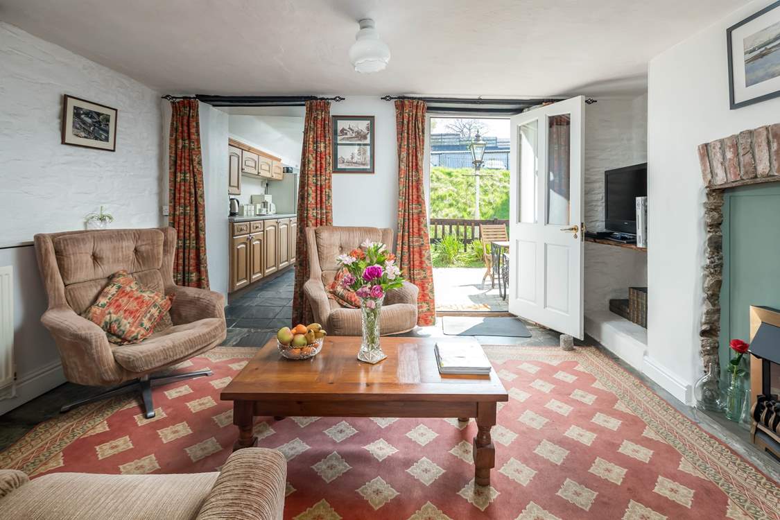 The sitting-room is the heart of the cottage and enjoys a view out across your private patio to the platform.