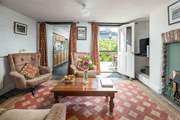The sitting-room is the heart of the cottage and enjoys a view out across your private patio to the platform.