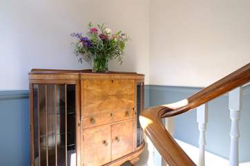 The elegant staircase with beautiful period furniture.