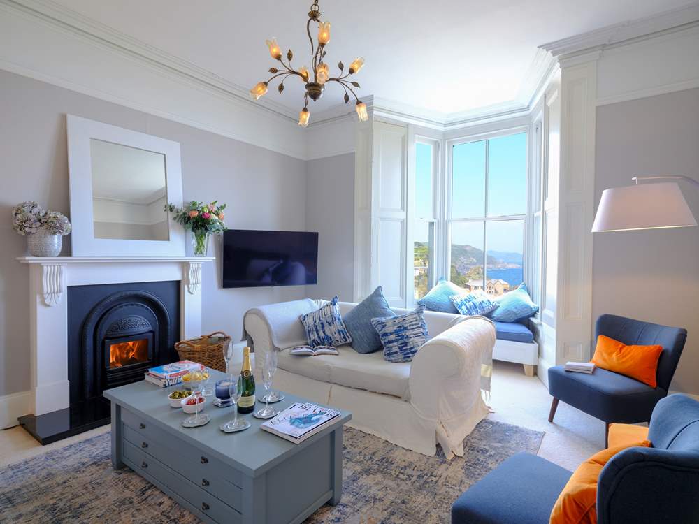 The beautiful sitting-room where you can enjoy harbour views at any time of year. Please note the fire is ornamental only.